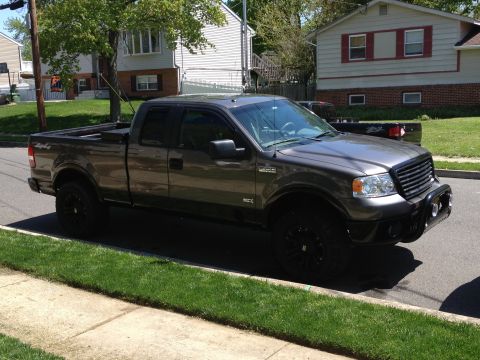 2008 Ford F-150 - This pickup truck is parked on a residential street with houses in the background.