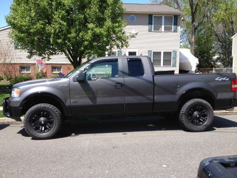 2008 Ford F-150 - Side view of a gray Ford F-150 pickup truck with aftermarket wheels and tires.