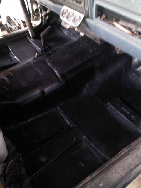 1987 Jeep Comanche - Interior view of a vehicle, showing black flooring and a dashboard with three gauges.