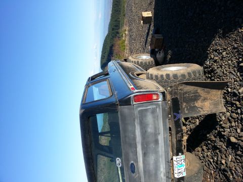 1979 Ford Bronco - This Ford Bronco is equipped with large off-road tires and a rear-mounted plow, suggesting it's used for terrain.