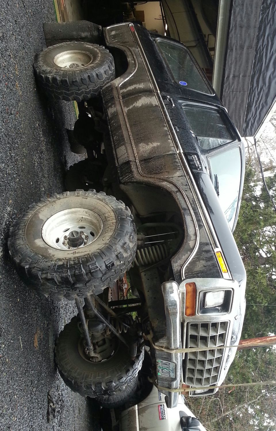Black lifted Ford Bronco with large tires and custom grille