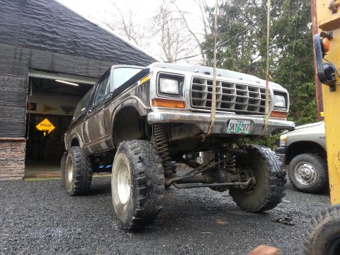 1979 Ford Bronco - This modified 1978 Ford Bronco features a lifted suspension and oversized tires, with another vehicle visible to the right.