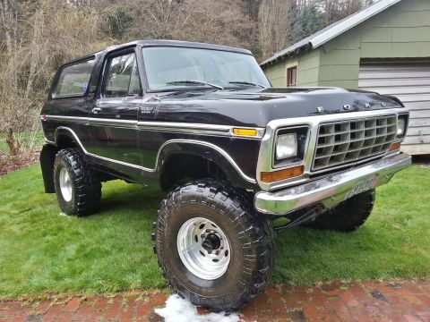 1979 Ford Bronco - This lifted 1979 Ford Bronco features a prominent chrome grille and large off-road tires.