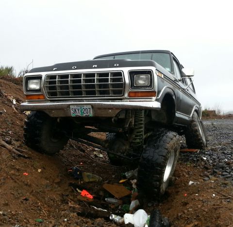 1979 Ford Bronco - This modified Ford Bronco is shown off-roading on a dirt and gravel path.
