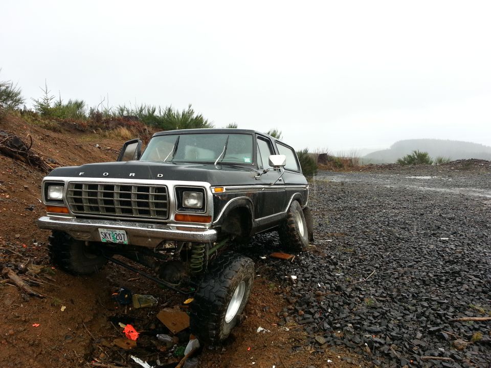 Black lifted Ford Bronco on a dirt and gravel road