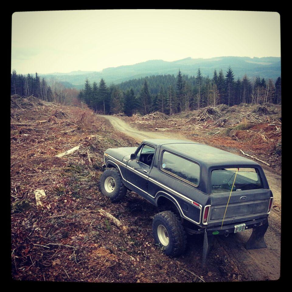 Black 1979 Ford Bronco 3q-front view on a dirt road