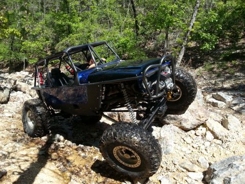 1967 Ford Mustang - This custom buggy navigates a rocky trail, its suspension and off-road capabilities.
