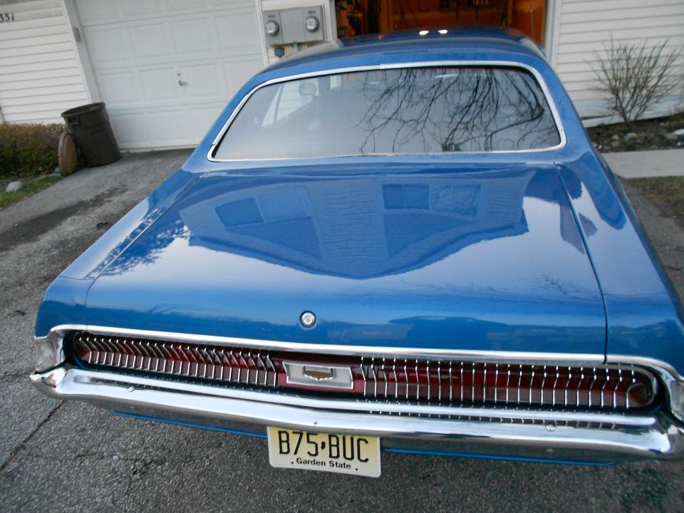 Rear view of a blue 1968 Mercury Cougar with a chrome grille and a New Jersey license plate