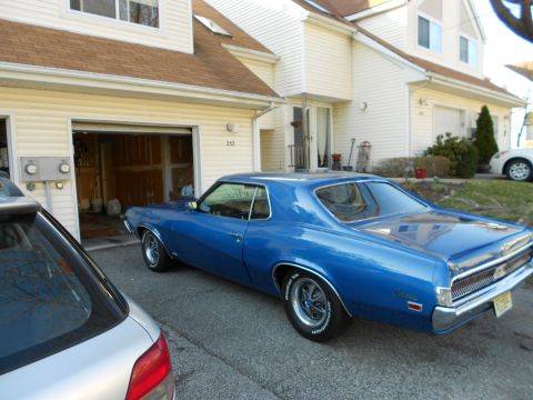 1968 Mercury Cougar - A blue 1969 Mercury Cougar is parked in front of a residential garage.