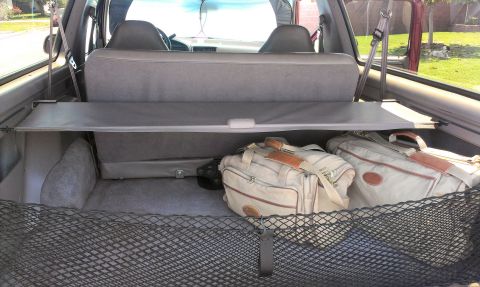 1994 Ford Bronco - The cargo area of a 1994 Ford Bronco is shown, complete with luggage and a cargo net.