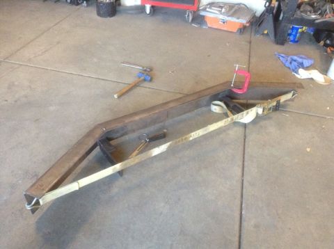 1995 Ford Bronco - Custom bumper fabrication in progress with tools and straps nearby.