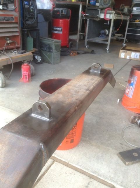 1995 Ford Bronco - A custom steel bumper section, likely for a truck or SUV, is shown resting on orange buckets in a workshop.