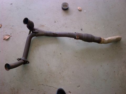 1994 Ford Bronco - This exhaust pipe assembly features a catalytic converter and dual outlet pipes, likely a replacement part for a vehicle.