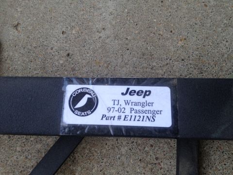 2000 Jeep Wrangler - A label indicates a Jeep TJ Wrangler passenger seat part number E1121NS from the 1997-2002 model years.