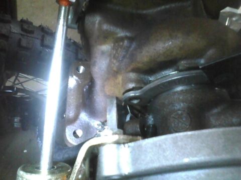 2003 Ford Crown Victoria - A close-up view of a rusty metal component, likely part of a vehicle's transmission system.