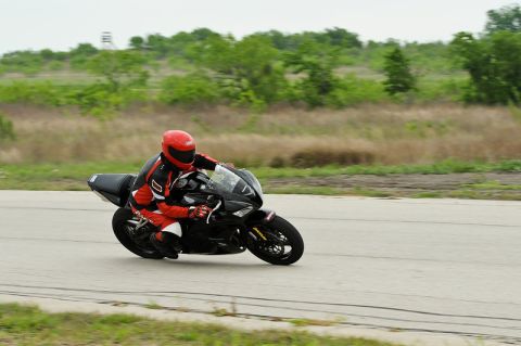 2001 Kawasaki KZ1000-A1 - Rider in full gear takes a turn on a sport motorcycle during a track day event.