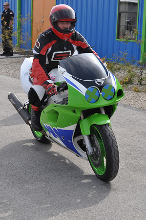 2001 Kawasaki KZ1000-A1 - Motorcycle with rider in full gear on asphalt road.