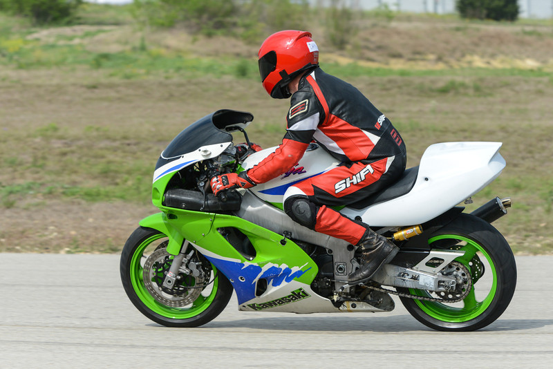 2001 Kawasaki KZ1000-A1 sportbike with rider in red and black gear