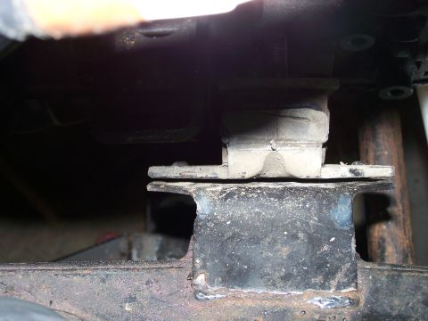 1988 Suzuki Samurai - Close-up of a vehicle's engine mount, showing a rubber isolator and metal bracket.