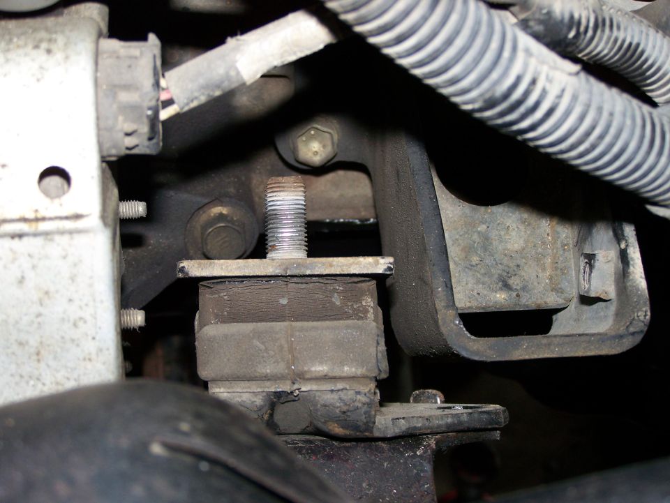 Close-up of a vehicle's engine mount with rubber dampening