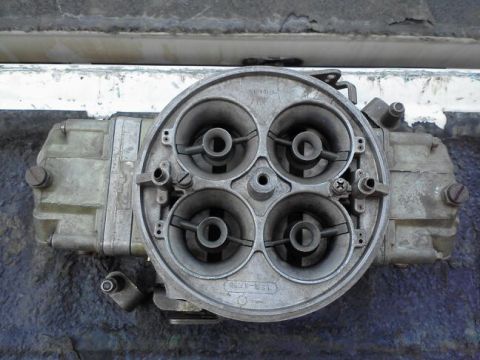 1995 Ford Bronco - This four-barrel carburetor features a top-down view, highlighting its four intake bores and visible casting numbers.