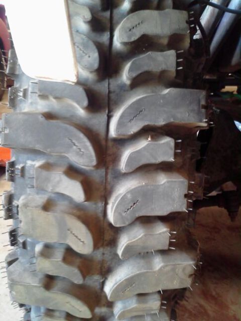 1995 Ford Bronco - Aggressive off-road tire tread pattern with deep lugs for maximum traction.