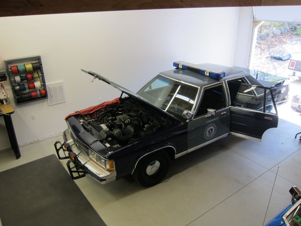 1991 Ford Crown Victoria LTD police car with hood and driver's door open, showing engine