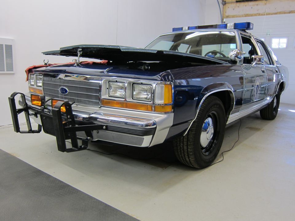 1991 Ford Crown Victoria LTD police car, front view, hood open, with push bumper and light bar