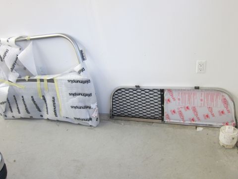 1991 Ford LTD Crown Victoria - Two vehicle grille guards are shown, one is a mesh guard and the other is a tubular guard, both wrapped for protection.