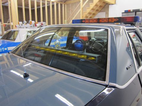 1991 Ford LTD Crown Victoria - Interior view of a 1991 Ford Crown Victoria LTD police car, showing equipment behind the rear window.