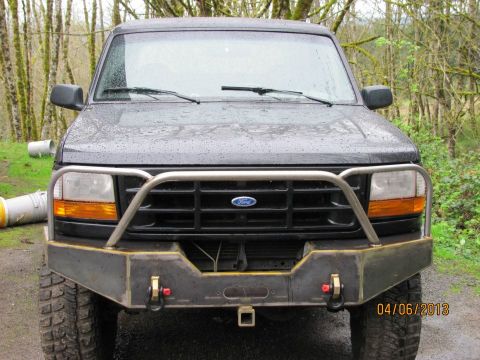 1989 Ford Bronco - Front view of a dark gray Ford Bronco with an aftermarket bumper and brush guard.
