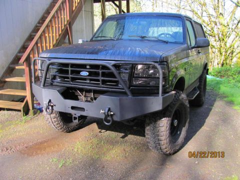 1989 Ford Bronco - This 1989 Ford Bronco features a custom front bumper and brush guard, seen parked outdoors.