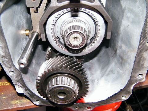 2004 Ford Crown Victoria - Close-up view of internal transmission components, including gears and a shift linkage.