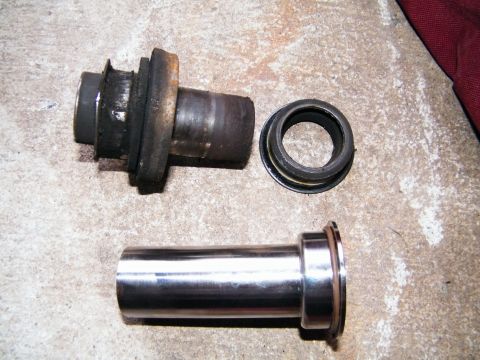 2004 Ford Crown Victoria - These automotive parts appear to be related to a vehicle's suspension system, possibly a bushing or bearing assembly.