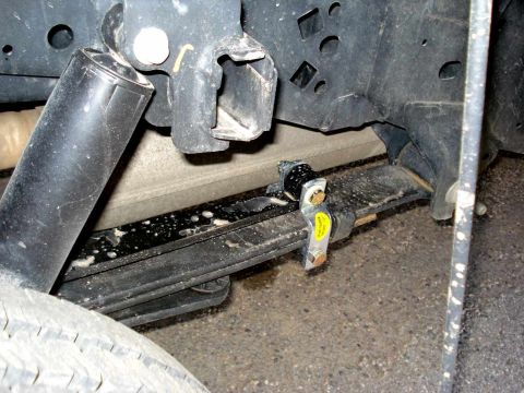 2008 Ford Crown Victoria - Close-up view of the rear leaf spring and shock absorber assembly on a vehicle.