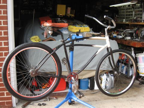 1994 Ford Bronco - Bicycle undergoing maintenance on a repair stand in a cluttered garage setting.