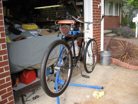 1994 Ford Bronco - A bicycle is mounted on a repair stand, with tools and a red gas can visible in the background.