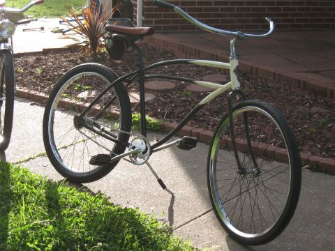 1994 Ford Bronco - A cruiser bicycle with a distinctive frame design is parked on a sidewalk next to another bicycle.