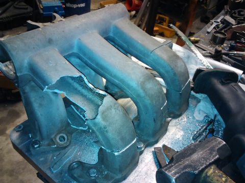 1995 Ford Probe - This intake manifold shows significant damage to its runners, indicating a failure or impact.