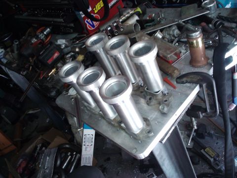 1995 Ford Probe - A custom intake manifold is shown on a cluttered workbench with various tools and parts.