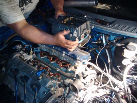 1995 Ford Probe - Mechanic installs a supercharger onto a Mazda engine. The registry claims this is a 1995 Ford Probe, but the engine clearly shows Mazda bra…