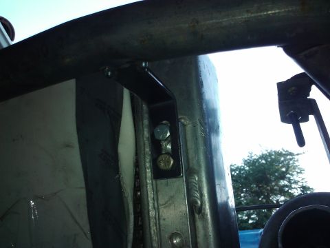 1995 Ford Probe - Close-up view of a roll cage mounting bracket inside a vehicle.