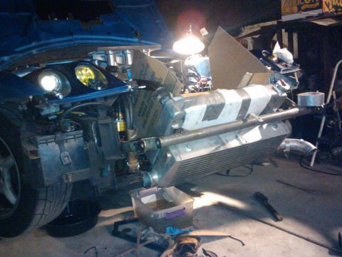 1995 Ford Probe - Engine bay modification with a large intercooler, showing parts and wiring.