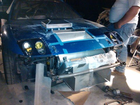 1995 Ford Probe - Customizations are underway on this blue vehicle, a prominent hood scoop and extensive front-end modifications.
