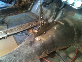 1962 Ford Ranchero - Close-up view of the interior floor pan and shifter mechanism, showing significant rust and wear.