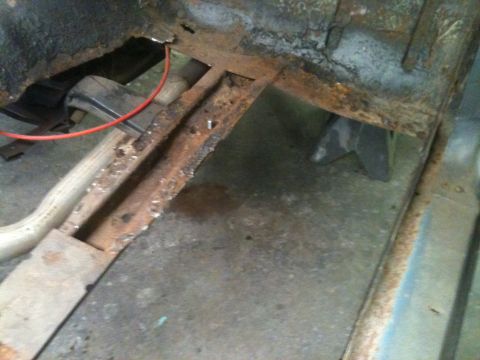 1962 Ford Ranchero - Severe rust damage is visible on the vehicle's frame and floor pan.