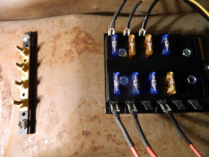 1962 Ford Ranchero - Close-up of a vehicle's electrical system showing a fuse box and terminal strip with wiring.