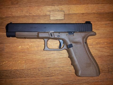 1996 Ford Bronco - A Glock 35 pistol with a brown frame and black slide is shown from the side.