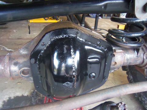 1968 Ford Bronco - Close-up of a rear differential cover, likely an aftermarket upgrade, on a vehicle's axle.