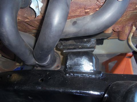 1968 Ford Bronco - This photo shows a close-up view of a vehicle's engine mount and exhaust manifold system.
